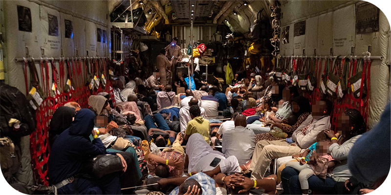 Evacuees sitting and lying down on board a Royal Australian Air Force C-130J Hercules during the military assisted departure from Port Sudan to Cyprus.